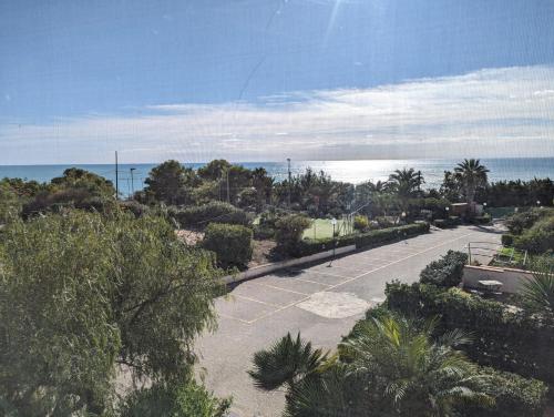 an empty parking lot with the ocean in the background at Sciacca Holiday Home in Sciacca