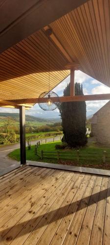 a view from the deck of a house with a chandelier at Le petit gîte de Borgoumont à Stoumont in Stoumont