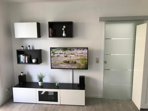 a living room with a tv on a wall at Strandnahes Ostsee Apartment Malum in Zierow