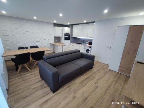 a living room with a black couch and a table at Apartment Feldkirch in Feldkirch