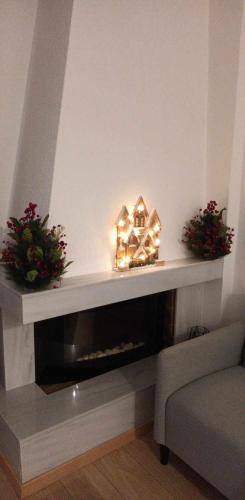 a living room with a fireplace with a house on it at S & K Apartment free indoor parking in Athens