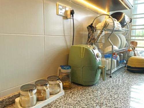 a kitchen counter with jars and a toaster at pen kyu house1 in Kota Samarahan