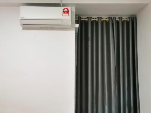 a room with a heater and a curtain at pen kyu house1 in Kota Samarahan