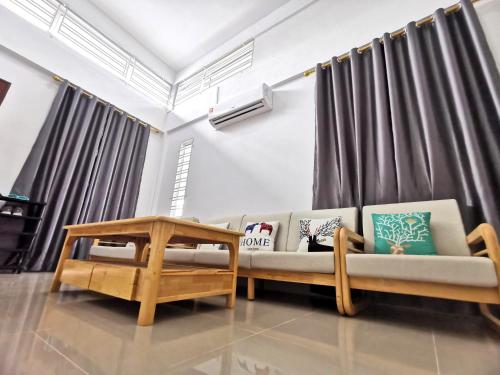 a living room with a couch and a table at pen kyu house1 in Kota Samarahan