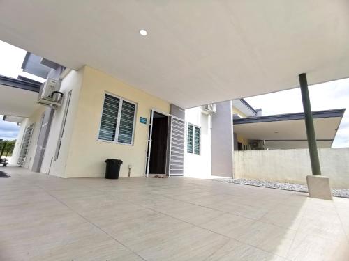 a white house with a courtyard with a door at pen kyu house1 in Kota Samarahan
