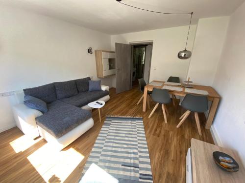 a living room with a couch and a table at Ferienwohnungen an der Schlösselmühle in Amtsberg