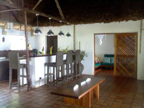 - un salon avec un bar, une table et des chaises dans l'établissement nosykombafafa, 