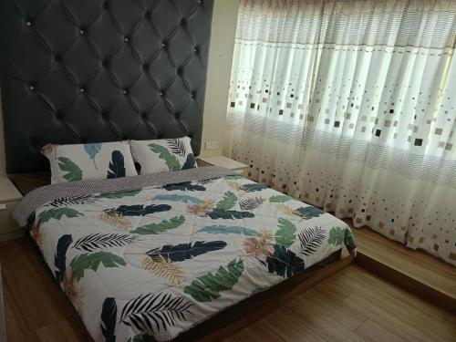 Best Sekinchan homestay في سيكينتشان: غرفة نوم مع سرير مع اللوح الأمامي ونافذة