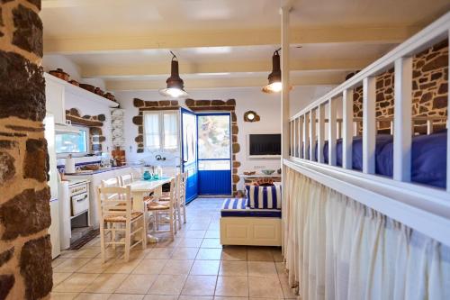 a kitchen with a bed and a table in a room at Aspros Pyrgos in Volissos