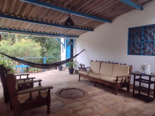 a living room with a hammock and a patio at hostel kay pacha in Maceió