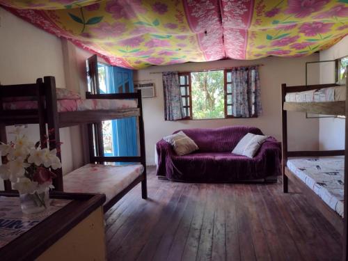 a living room with bunk beds and a purple couch at hostel kay pacha in Maceió