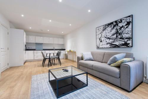 a living room with a couch and a table at Stunning Luxury 2 Bedroom London Apartment in London