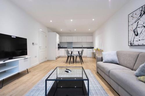 a living room with a couch and a table at Stunning Luxury 2 Bedroom London Apartment in London