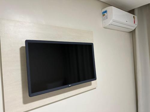 a flat screen tv hanging on a wall at Hotel Flex Tatuapé in Sao Paulo