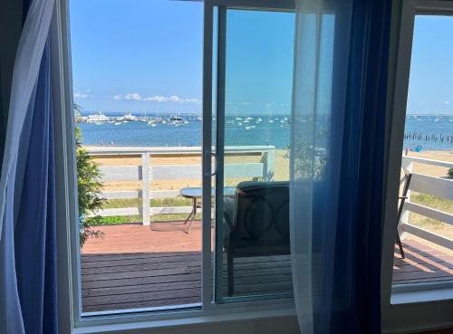 a room with a view of the beach from a window at Lotus Provincetown in Provincetown