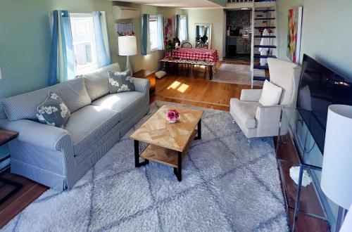 a living room with a couch and a coffee table at Lotus Provincetown in Provincetown