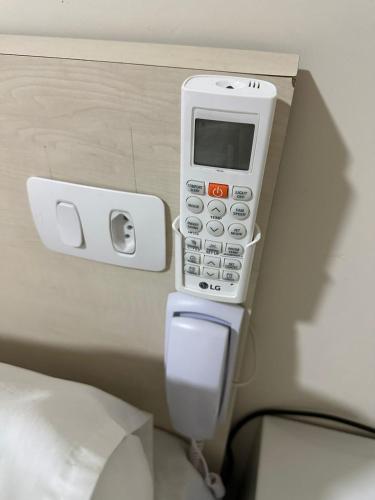 a cell phone is attached to a toilet in a room at Hotel Flex Tatuapé in Sao Paulo