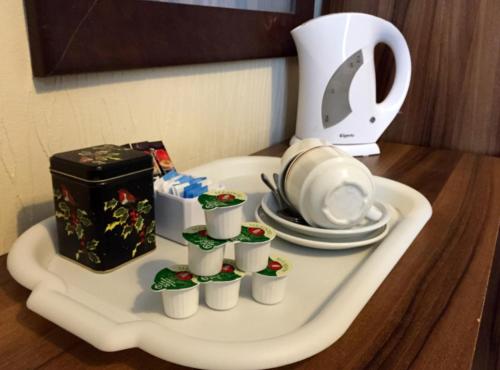 a white tray with cups and plates on a table at The Melville Hotel - Central Location in Blackpool