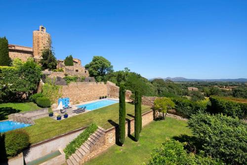 an estate with a swimming pool and a castle at Casa Rufina, Exclusive & Charming Stone House in Costa Brava in Pals