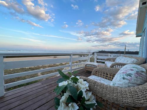 a porch with chairs and a view of the ocean at Lotus Provincetown in Provincetown