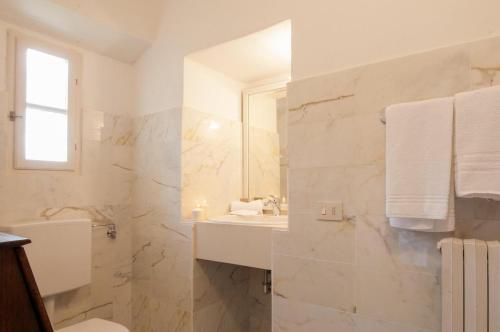 a bathroom with a toilet and a sink and a mirror at Apartments Ava in Babići