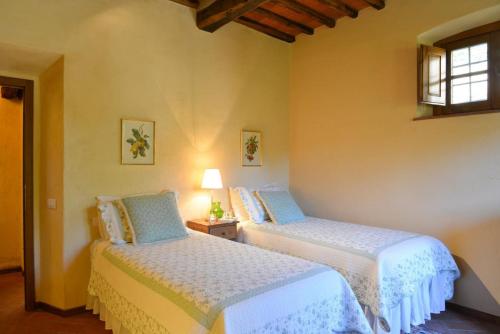 two beds in a room with a window at Apartments Ava in Babići
