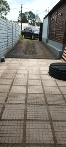 a brick driveway with a car parked in a parking lot at Cabañas niño9 in Villa Dolores