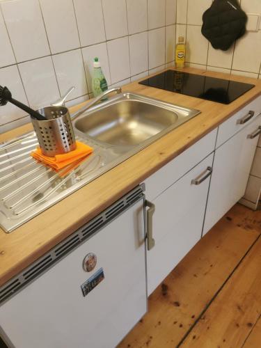 a kitchen counter with a sink and a pot at Ferienwohnung Auf dem Georgenberg in Naumburg