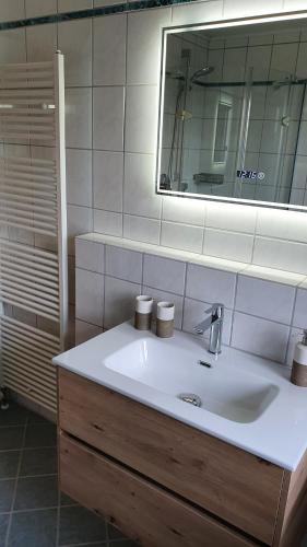 a bathroom with a sink and a mirror at Ferienwohnungen**** Sophie & Luca in Bad Grönenbach