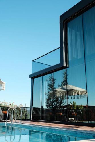 a building with a swimming pool with a large window at Velour Hotel Spa Restaurant in Sakarya