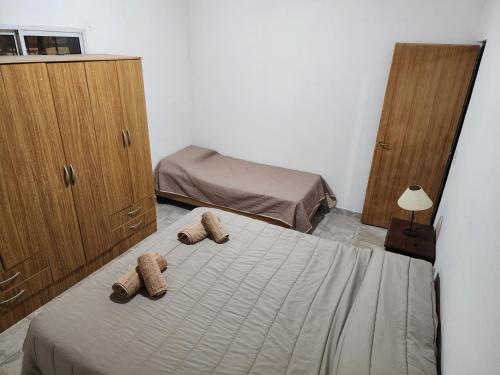 1 dormitorio con 1 cama con 2 toallas en Rincon house en Rincón de los Sauces