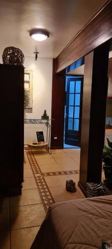 a room with a bed and a door with a window at Red Rose in Cabo Frio