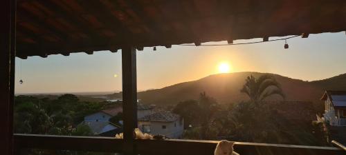a view of the sunset from the window of a house at Red Rose in Cabo Frio