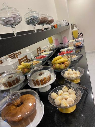 a buffet line with many different types of food at Hotel Flex Tatuapé in Sao Paulo