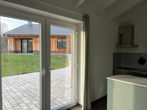 cocina con puerta corredera de cristal que da a un patio en Ferienhaus Auszeit mit Sauna, en Schwarz