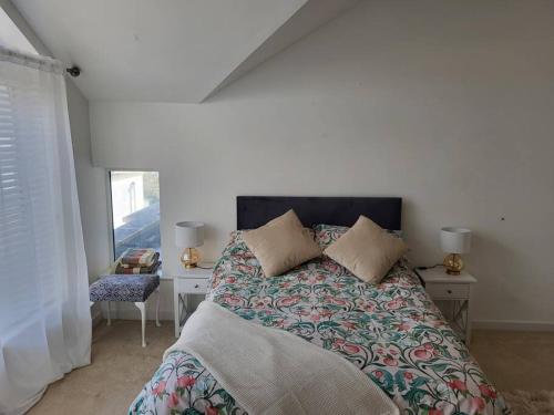a bedroom with a bed and a desk and a window at Aquavista Penthouse in Wyke Regis