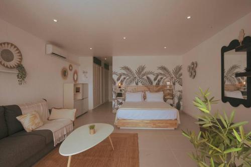 a living room with a bed and a couch at Studio magnifique vue sur mer in Saint Martin