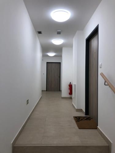 an empty hallway with white walls and a door at Apartmán Bára in Cerny Dul