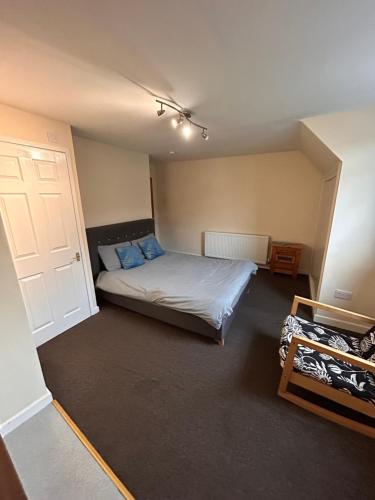 a bedroom with a bed and a white door at The Nook in Bedford