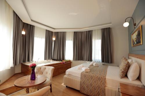 a hotel room with a bed and a table at Newalla Hotel Old City in Istanbul