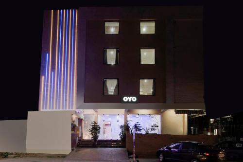 a building with an omg sign on the front of it at Capital O Hotel Pink Peral in Jaipur