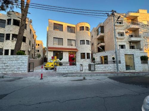 a yellow car parked in front of some buildings at 8/ Antica jabalal-lwebdeh in Amman