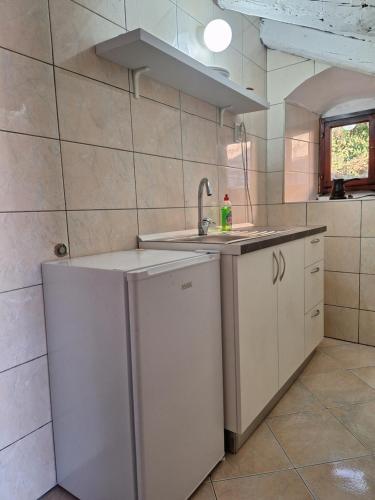 a kitchen with a sink and a dishwasher at Forteca home in Perast