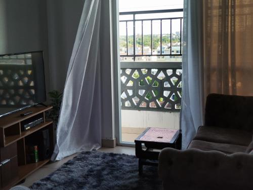 a living room with a large window and a couch at Millan Homes Nyali in Mombasa