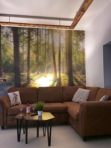 a living room with a large mural of a forest at Barnaby’s Barn in Carmarthen