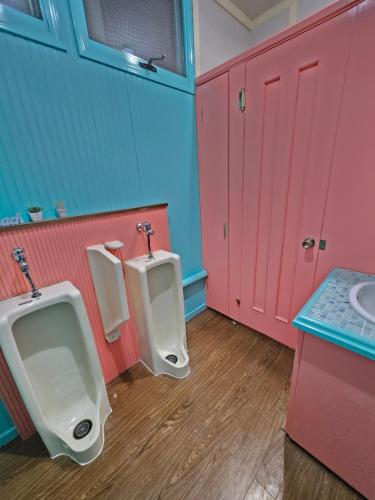 a bathroom with two urinals and a sink at White House ホワイト ハウス in Shimukappu