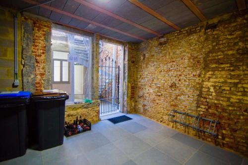 a room with a brick wall and a window at Residence Royal Sélys, City-Center - Bike Parking and Outdoor in Liège