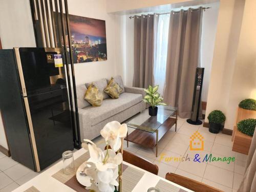 a living room with a couch and a table at 3 Bedroom Corner Panoramic View in Davao City