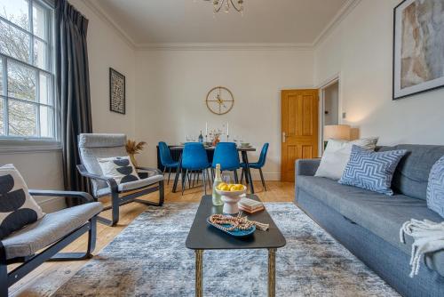 a living room with a couch and a table at 2-Bedroom Stunning, Modern & Spacious Apartment, near Ocean Village, Central Southampton - by Blue Puffin Stays in Southampton