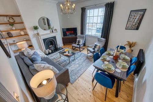 a living room with a couch and a table at 2-Bedroom Stunning, Modern & Spacious Apartment, near Ocean Village, Central Southampton - by Blue Puffin Stays in Southampton